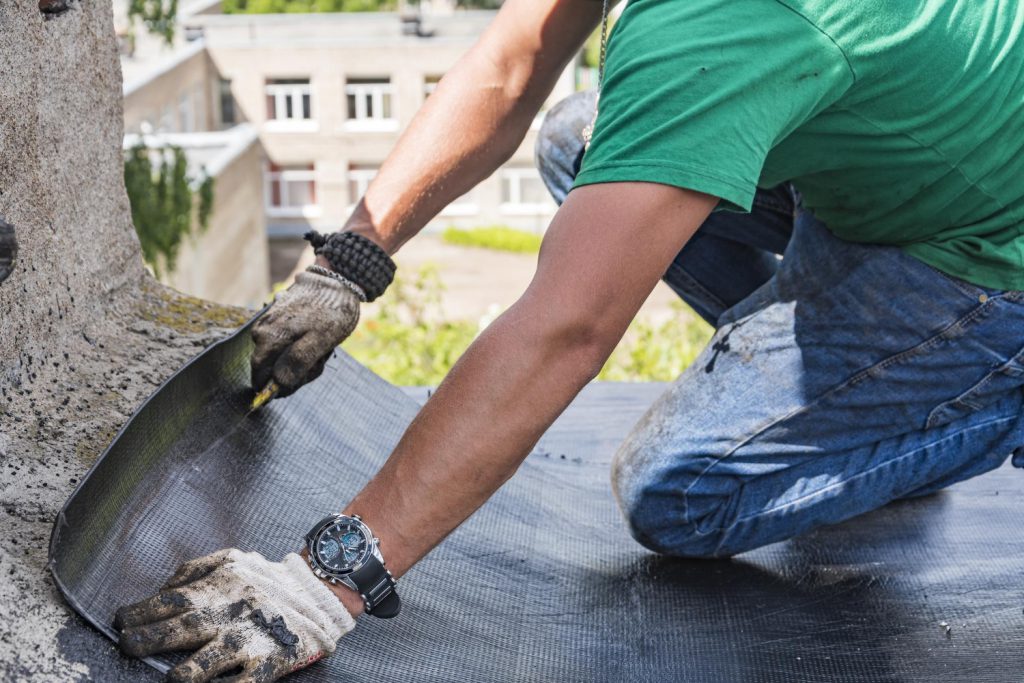 worker performs overhaul roof residential building